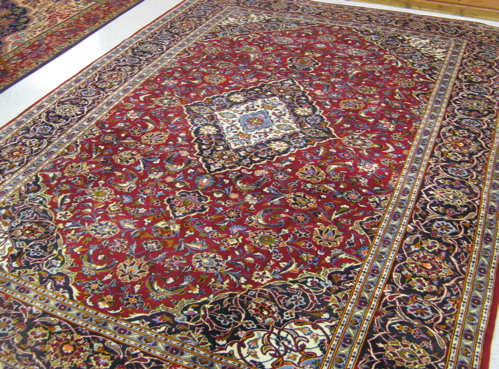 Appraisal: PERSIAN KASHAN CARPET floral and central floral medallion design on