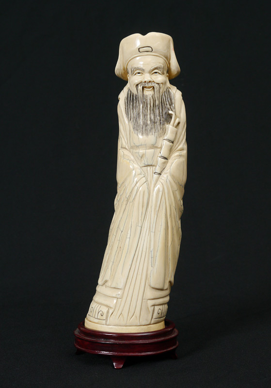 Appraisal: CARVED IVORY FIGURE OF A TAOIST PRIEST Carved tusk figure