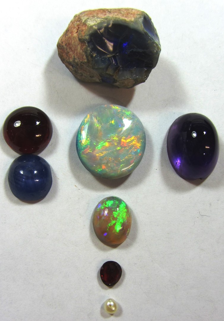 Appraisal: An unmounted oval opal a larger unmounted oval opal doublet