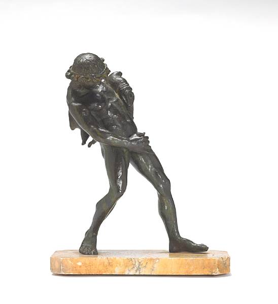 Appraisal: A patinated bronze figure of a faun with wine sackafter