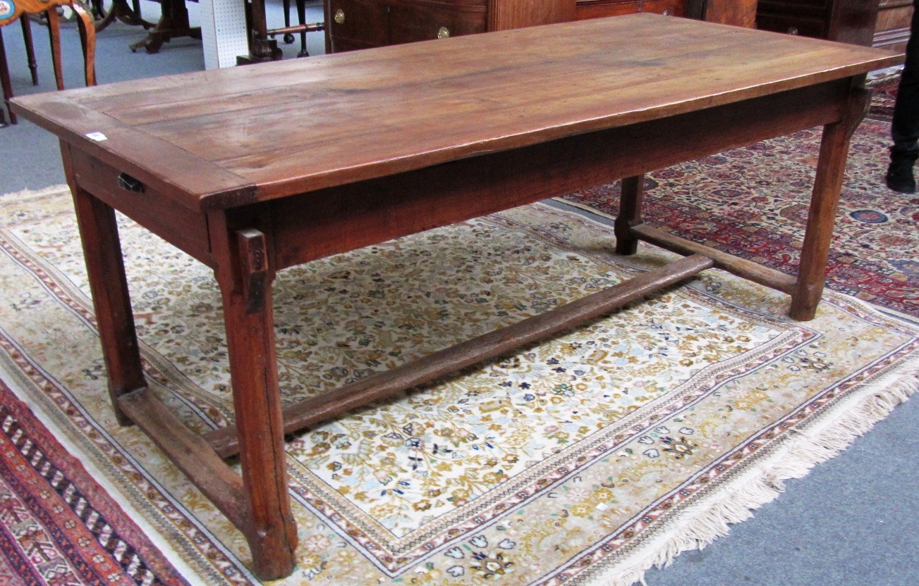 Appraisal: An early th century French chestnut and fruitwood dining table