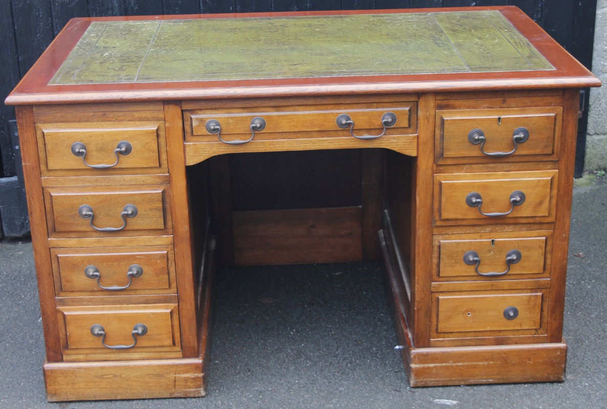 Appraisal: A thC mahogany finish writing desk the rectangular moulded overhanging