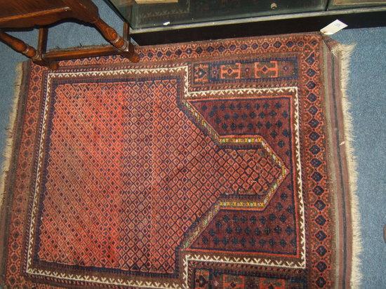 Appraisal: A wine ground Eastern rug x