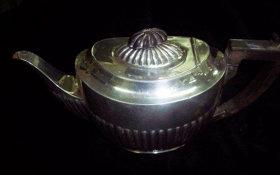 Appraisal: An oval half ribbed teapot with hinged cover Sheffield