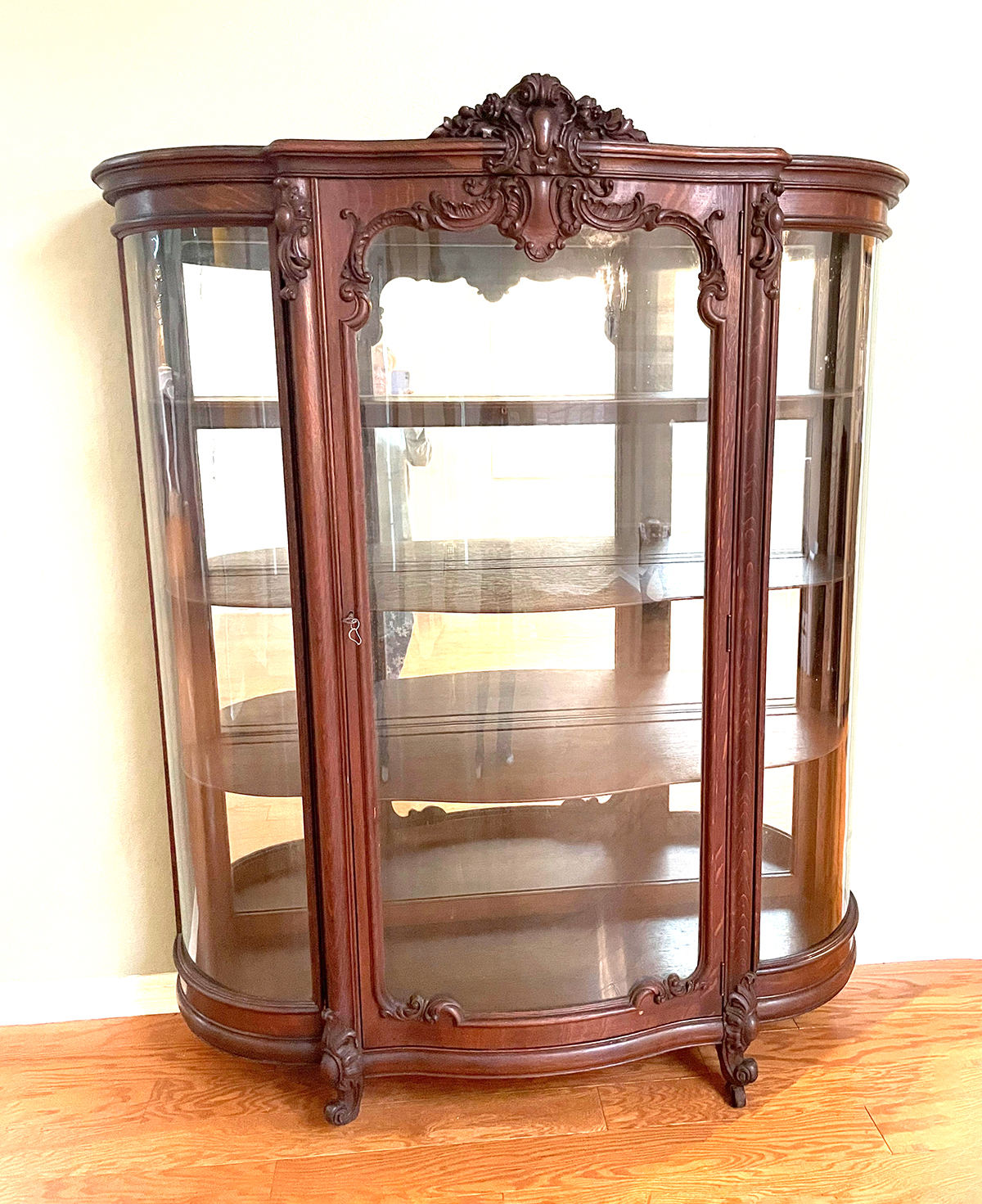 Appraisal: CARVED OAK TRIPLE BOWFRONT CHINA CABINET Surmounting carved foliate crest