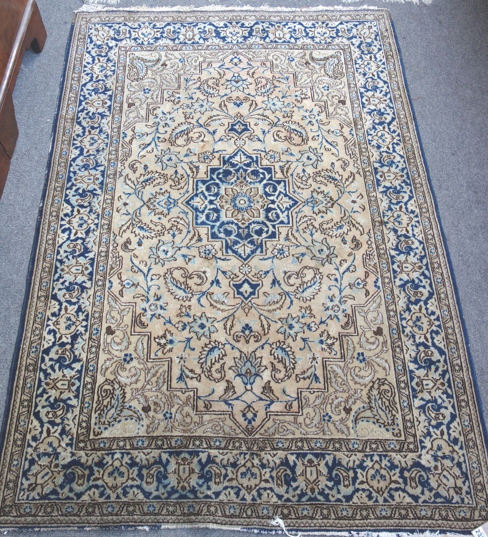 Appraisal: A Tabriz rug Persian the fawn field with an indigo