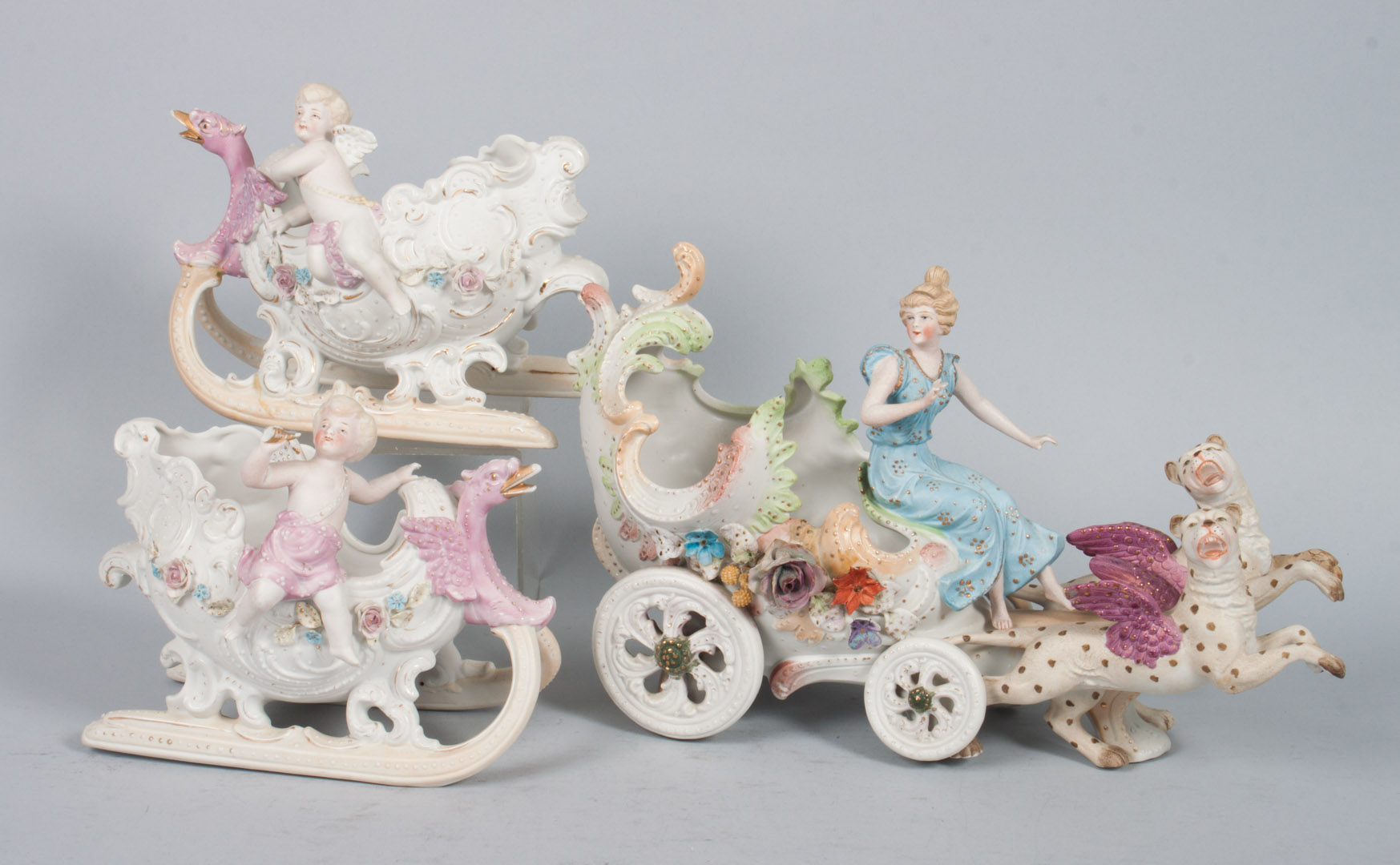 Appraisal: Three German painted bisque porcelain groups early th century Chariot