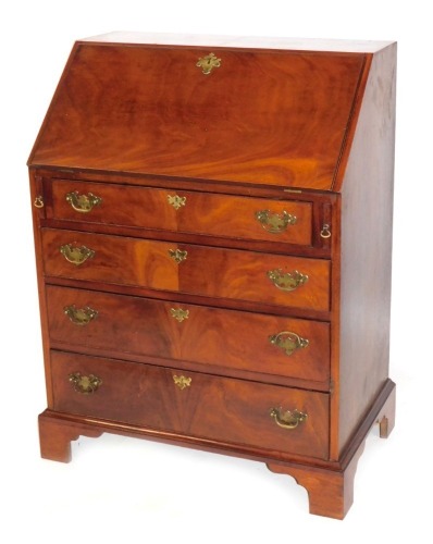 Appraisal: A thC mahogany bureau the fall flap above an arrangement