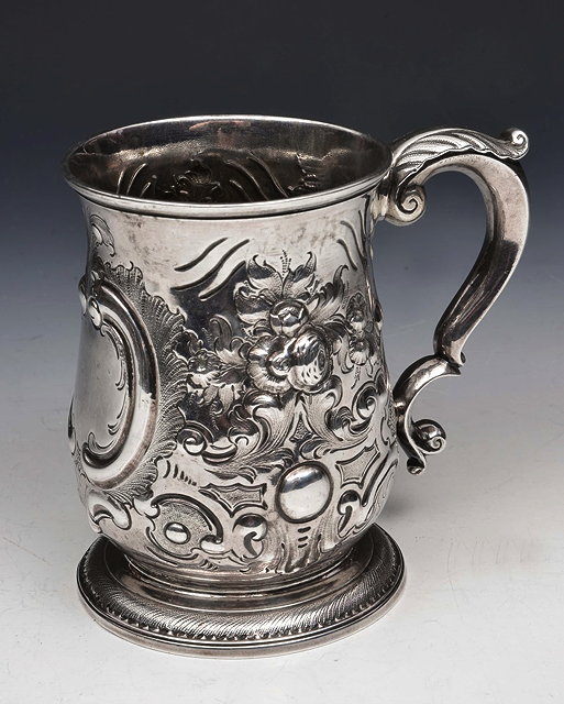 Appraisal: A GEORGE II SILVER TANKARD with chased foliate and scroll