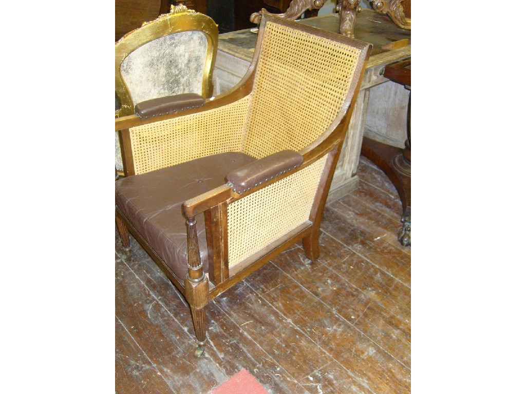 Appraisal: A Regency mahogany bergere chair with cane panelled back and