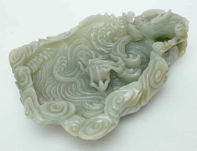 Appraisal: A CHINESE JADE DRAGON DISH th century Carved as a