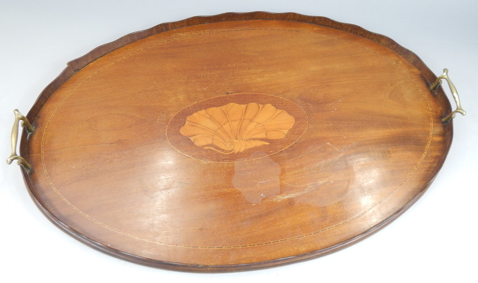 Appraisal: An Edwardian mahogany oval galleried tray with two brass handles