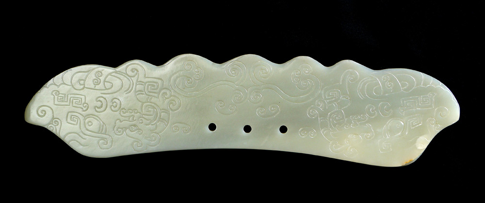 Appraisal: DECORATIVE CARVED SERPENTINE ORIENTAL POLEARM BLADE Carved with clouds and