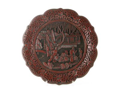 Appraisal: A Chinese red cinnabar lacquer dish moulded and carved with