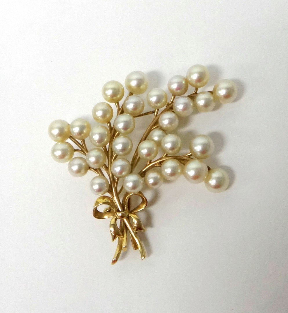 Appraisal: A gold and cultured pearl set brooch designed as a