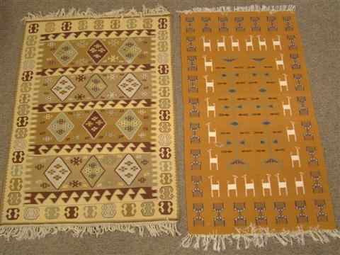 Appraisal: A COLLECTION OF INTERNATIONAL RUGS An orange and ivory mix