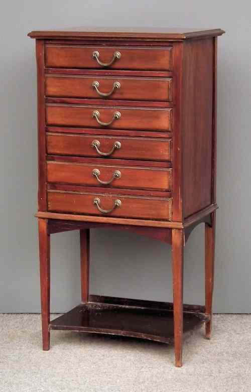 Appraisal: A late Victorian walnut music cabinet fitted six drawers with