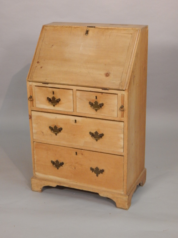 Appraisal: A thC stripped pine bureau the fall enclosing a fitted