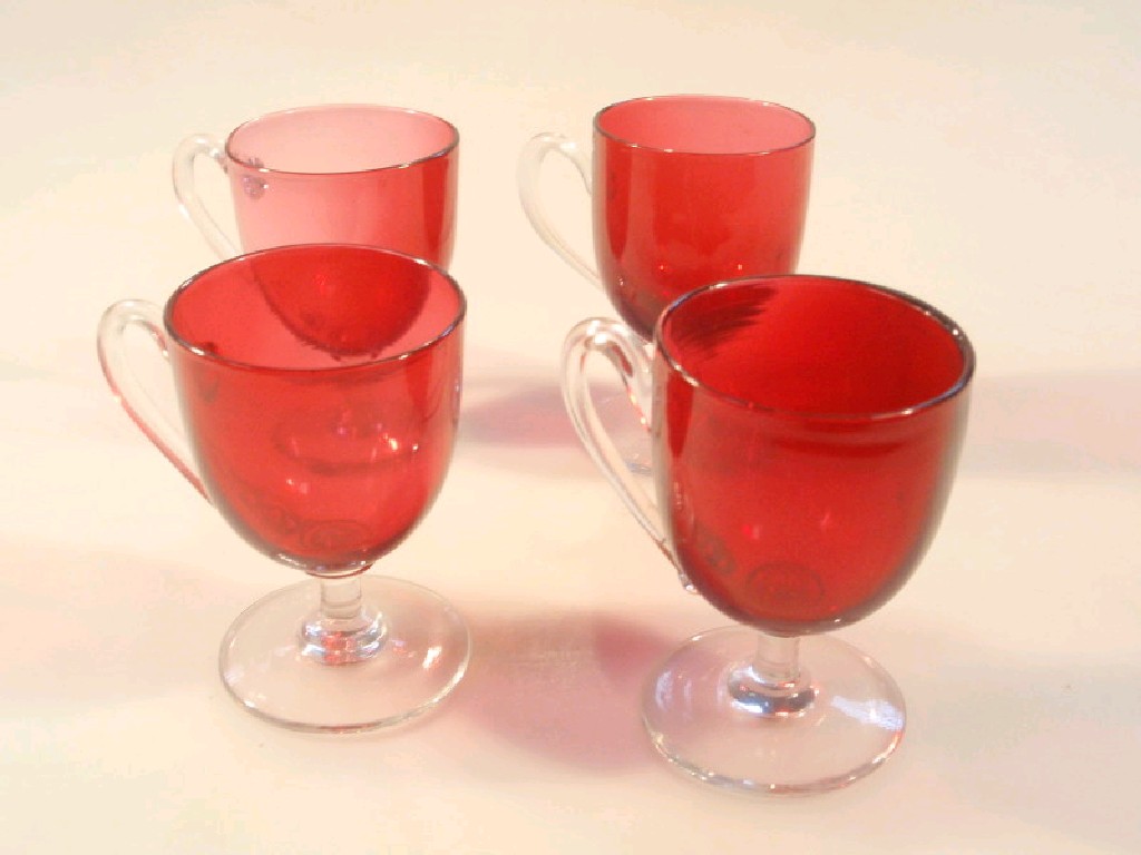 Appraisal: Four Victorian cranberry glass custard cups