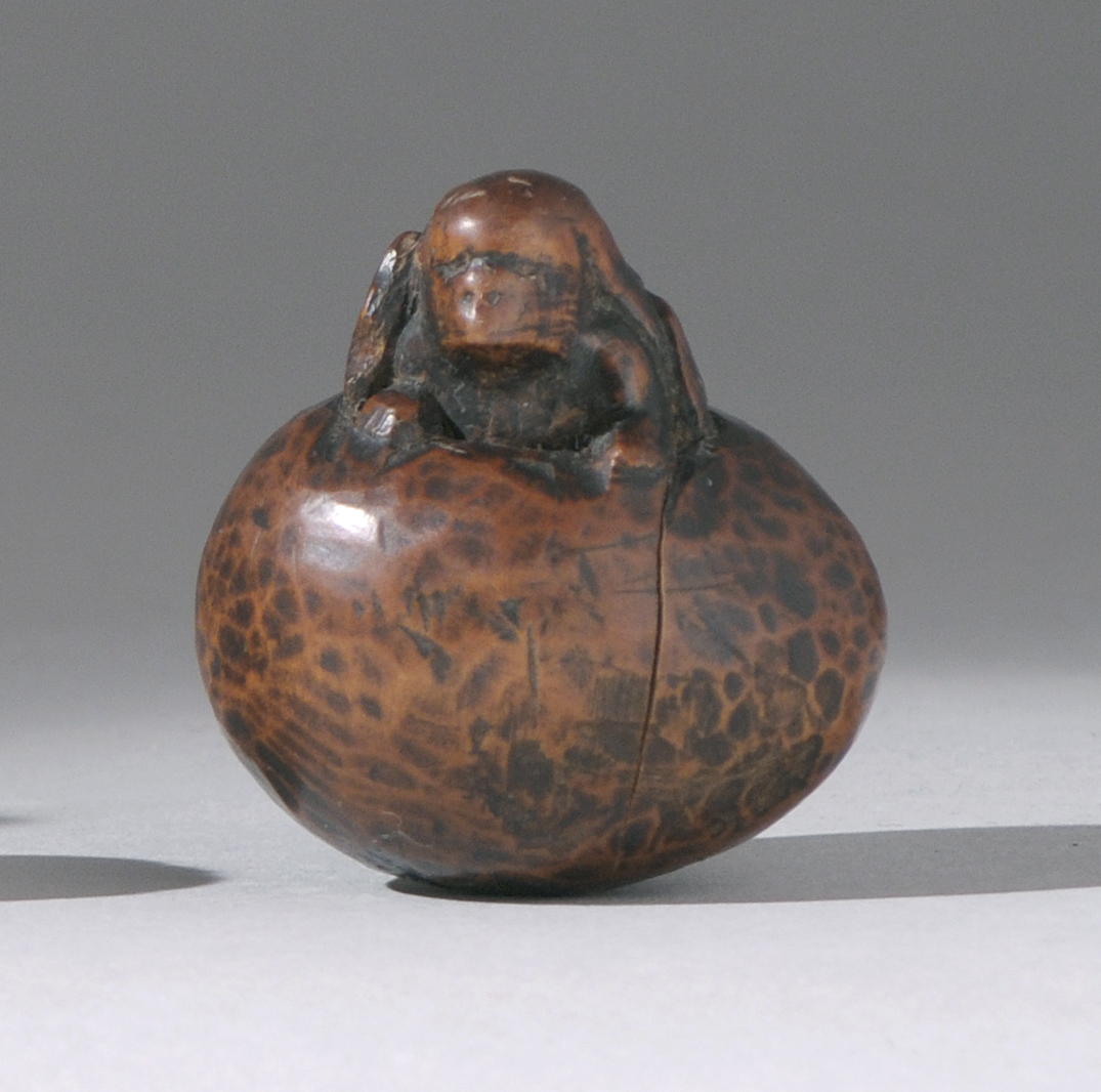 Appraisal: CARVED WOOD NETSUKE Meiji PeriodA tengu emerging from an egg