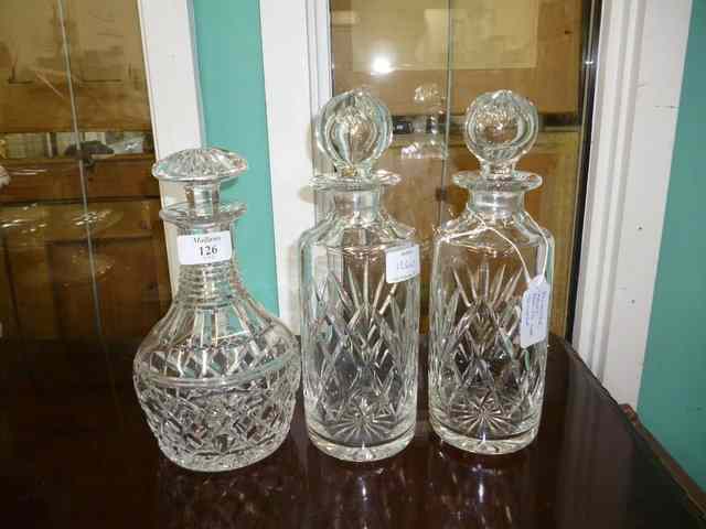 Appraisal: THREE CUT GLASS DECANTERS together with three silver decanter labels