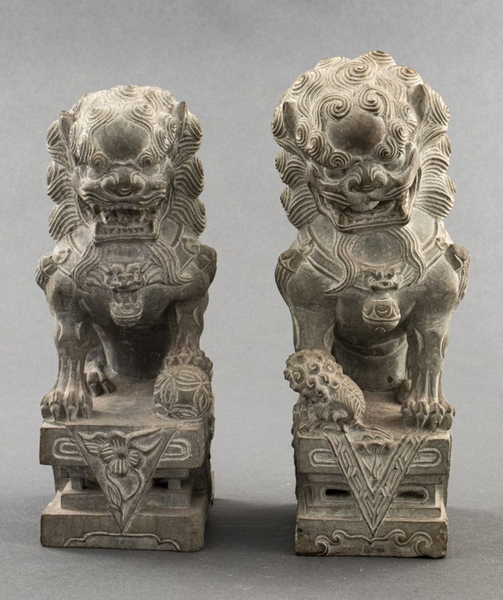 Appraisal: CHINESE CARVED STONE GUARDIAN LIONS PAIR Pair of carved stone