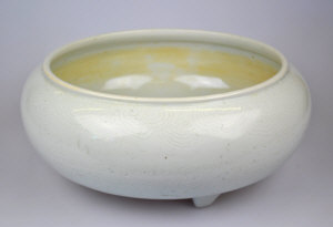 Appraisal: A Chinese white glazed bowl on three short legs incised