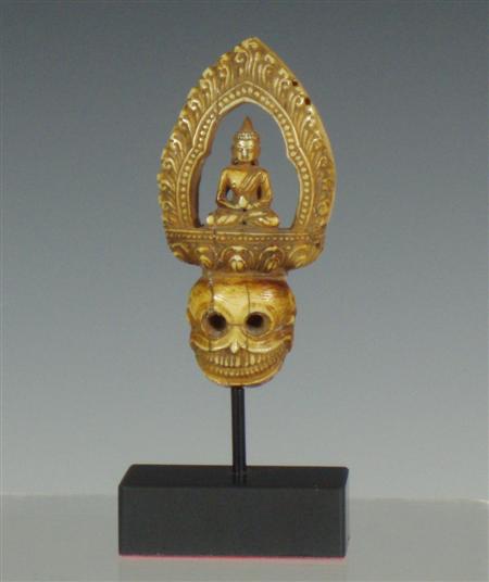 Appraisal: A th century carved ivory finial depicting a skull surmounted