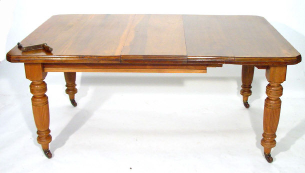 Appraisal: Edwardian Walnut wind out dining table with extra leaf and