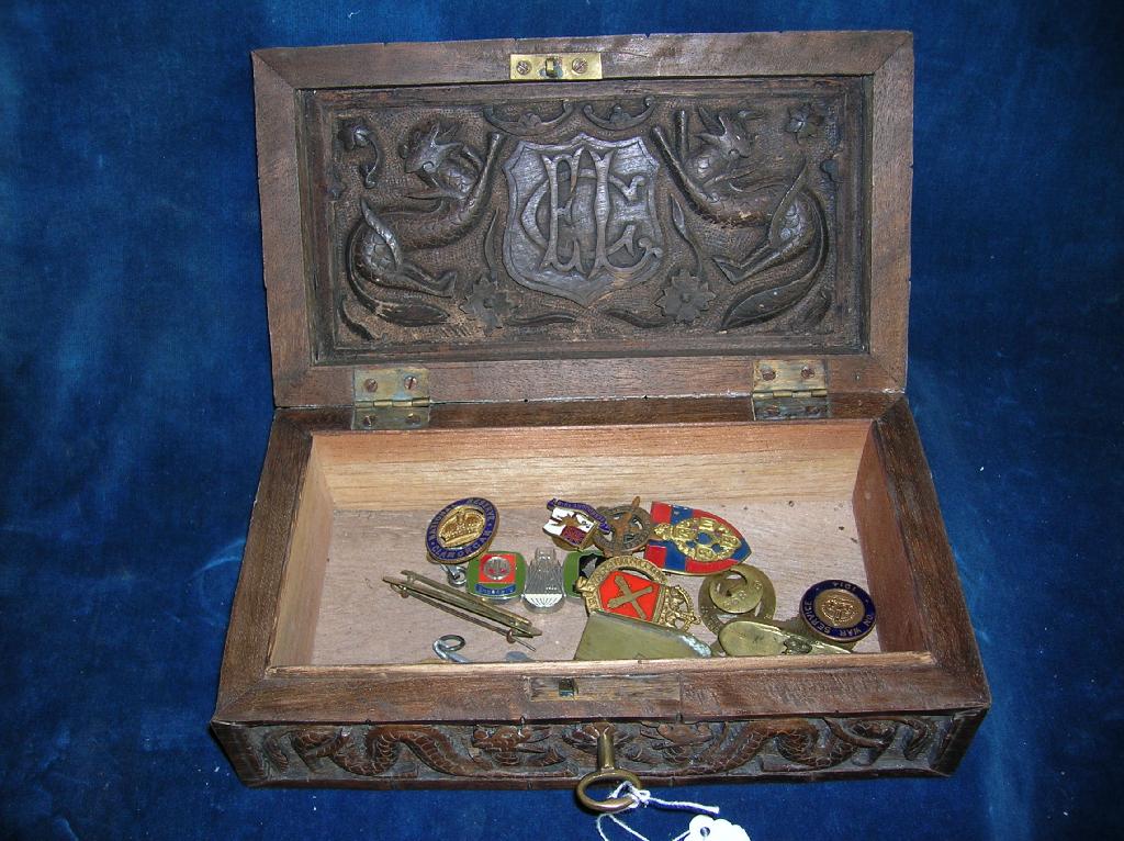 Appraisal: An attractive carved hardwood cigarette box the lid depicting two