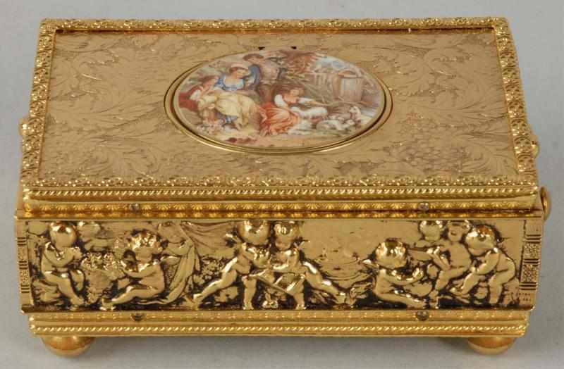 Appraisal: Brass Bird Music Box Description Plays well Depicting cherubs around