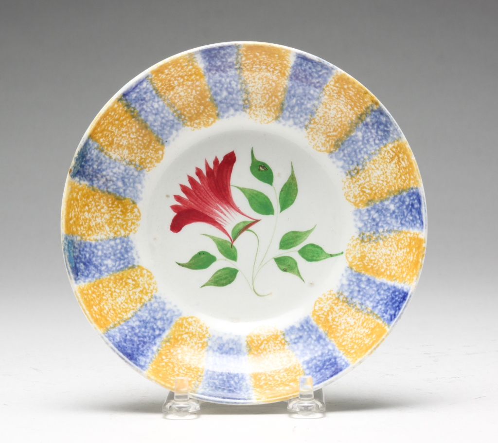 Appraisal: ENGLISH RAINBOW SPATTER SAUCER Mid th century Blue and yellow