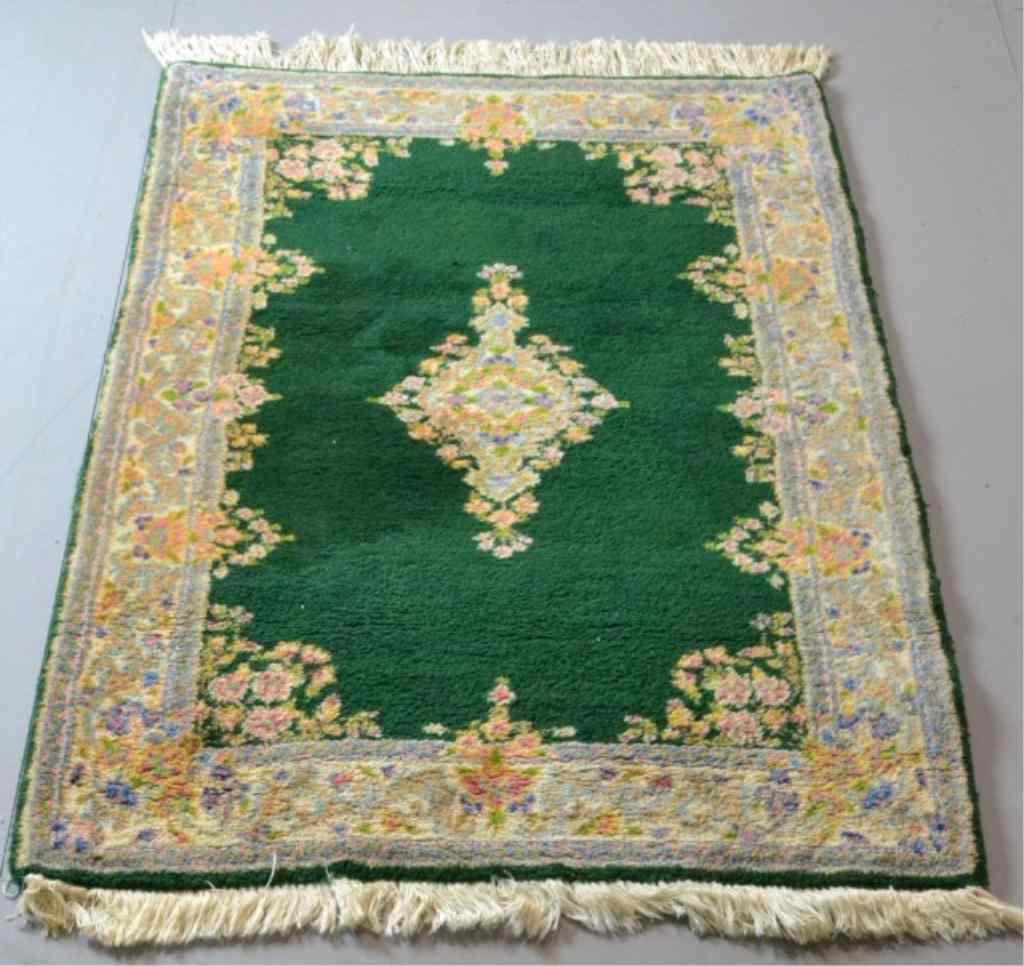 Appraisal: A FINE KIRMAN HAND-MADE WOOL RUGUnusual emerald green field with