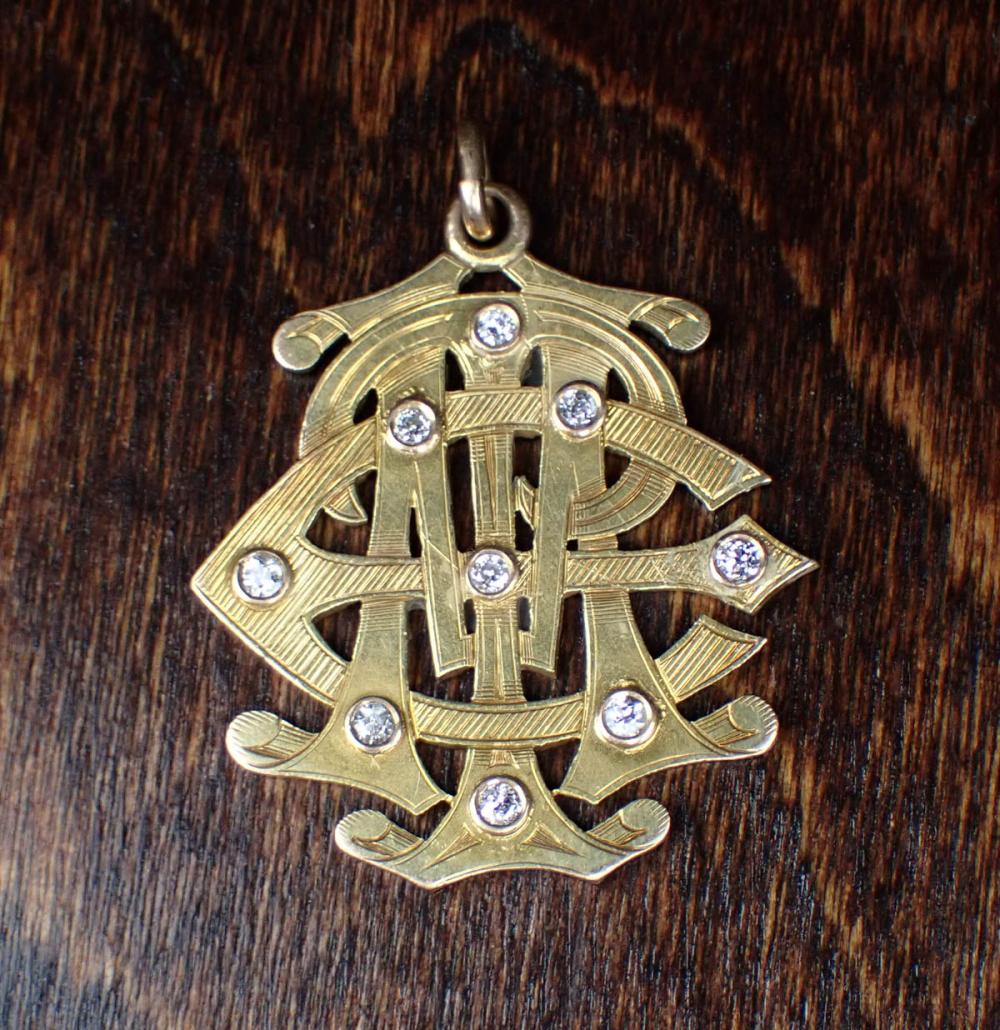 Appraisal: DIAMOND AND FOURTEEN KARAT GOLD MONOGRAM PENDANT three-letter monogram inset