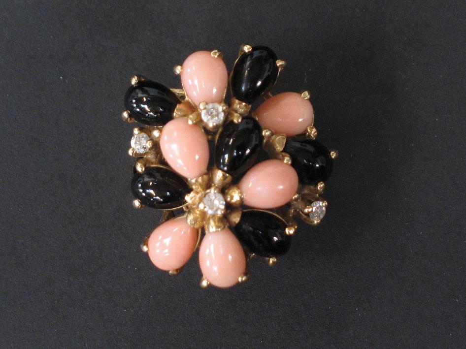 Appraisal: A 'S STYLE CORAL DIAMOND AND JET RING with a