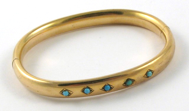 Appraisal: TURQUOISE AND FOURTEEN KARAT GOLD BANGLE The oval shaped hinged