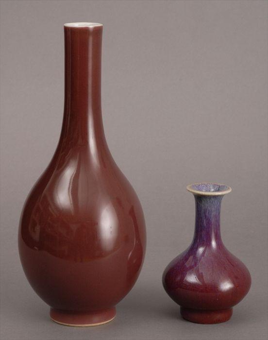 Appraisal: TWO CHINESE GLAZED PORCELAIN VASES The larger ox blood-glazed footed