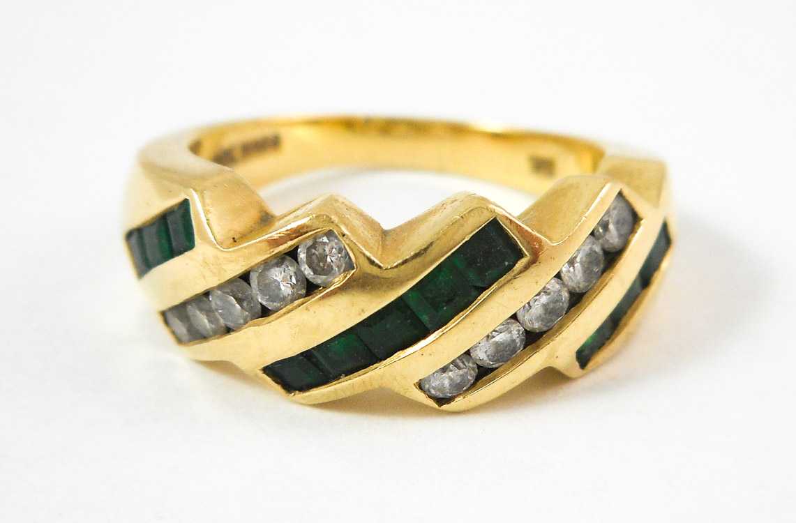 Appraisal: EMERALD DIAMOND AND FOURTEEN KARAT GOLD RING with three rows