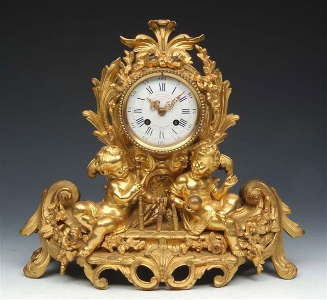 Appraisal: A FRENCH GILT METAL MANTEL CLOCK with white enamel dial