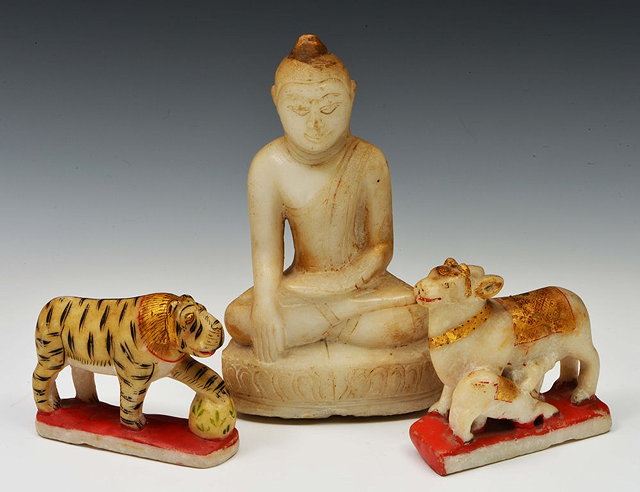 Appraisal: AN INDIAN CARVED ALABASTER BUDDHA a painted Indian alabaster tiger