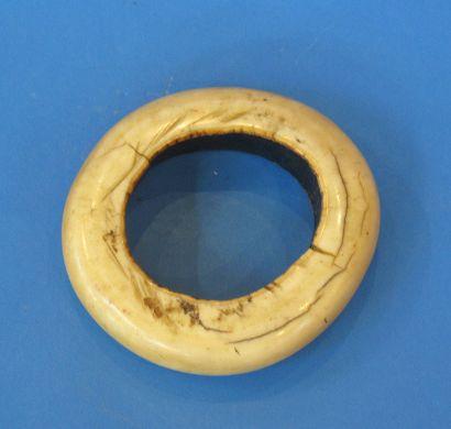 Appraisal: AN ETHNIC IVORY BANGLE with a well patinated surface dia