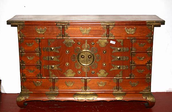 Appraisal: A Korean style wood sideboard Fashioned with multiple drawers surrounding