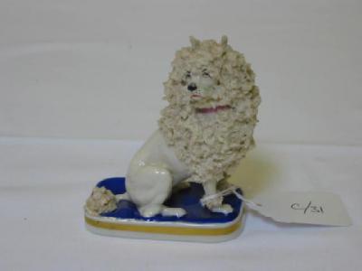 Appraisal: A PORCELLANEOUS MODEL OF A SEATED POODLE with lion-cut shredded