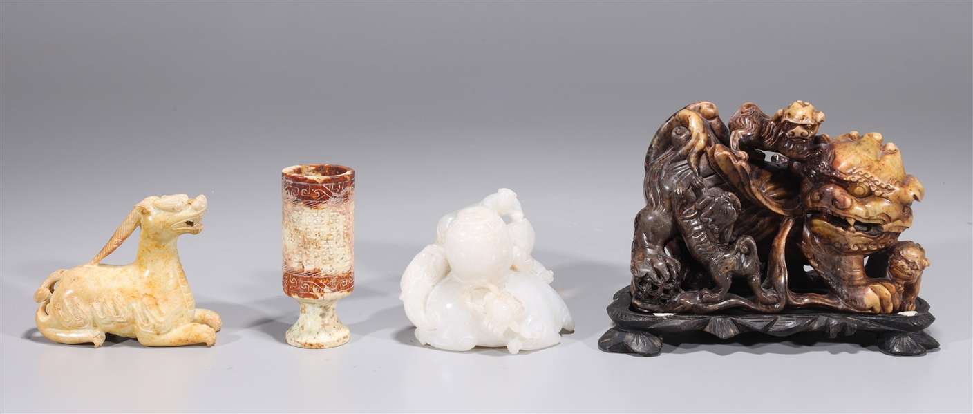 Appraisal: Group of four Chinese archaistic hardstone carvings including lion with