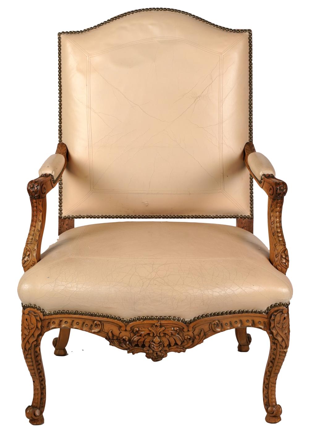 Appraisal: REGENCE-STYLE FAUTEUILthe foliage-carved frame covered with light tan leather Condition