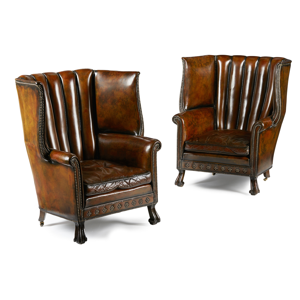 Appraisal: PAIR OF LEATHER UPHOLSTERED BARREL-BACK WING ARMCHAIRS EARLY TH CENTURY