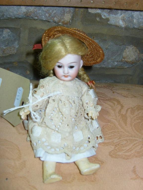 Appraisal: A small German bisque headed doll with closing brown eyes