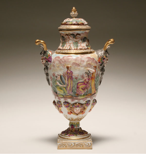 Appraisal: Capo di Monte double handled lidded urn applied Bacchanalian countenanced