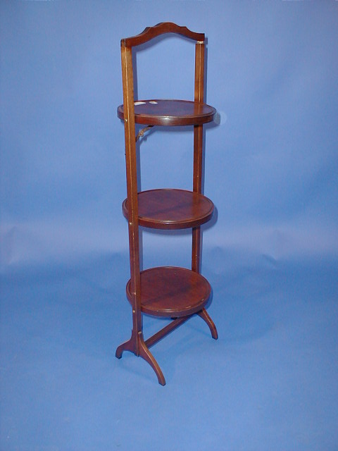 Appraisal: An Edwardian mahogany folding cake stand