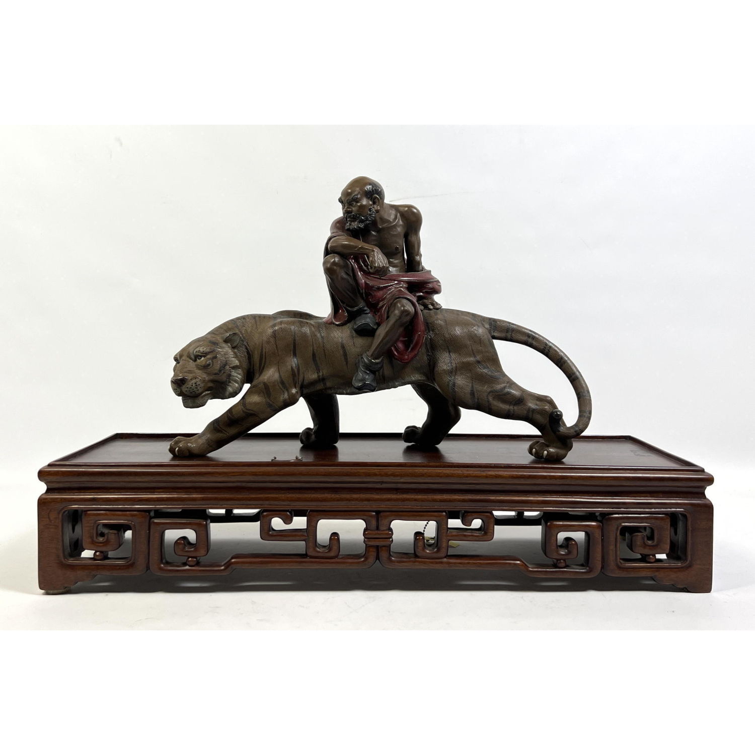 Appraisal: Chinese Figural Sculpture Bearded Man sits on Tiger Carved Wood